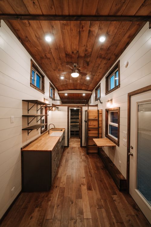 0133 Warm wooden accents and hand hewn details create farmhouse style in 330 square feet smallhometours.com 2
