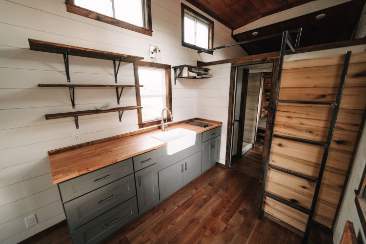0133 Warm wooden accents and hand hewn details create farmhouse style in 330 square feet smallhometours.com 3