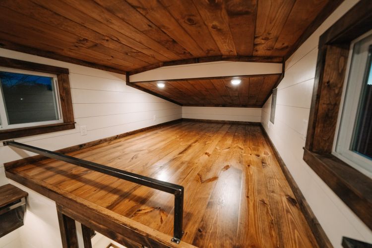 0133 Warm wooden accents and hand hewn details create farmhouse style in 330 square feet smallhometours.com 7