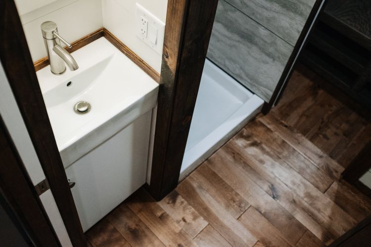 0133 Warm wooden accents and hand hewn details create farmhouse style in 330 square feet smallhometours.com 9