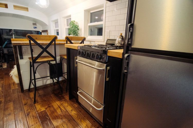 0166 A 12 inch roof raise elevates this luxurious custom Skoolie literally smallhometours.com 4