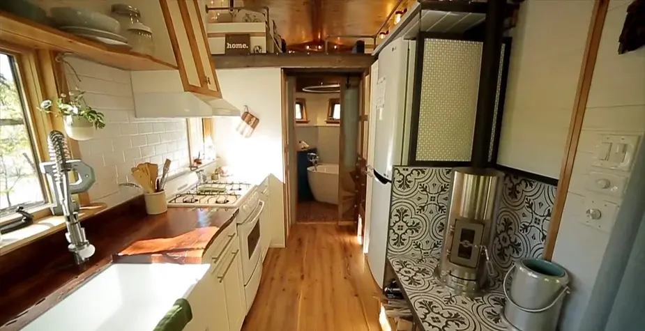0253 Tiny house with reclaimed materials bathroom penny floor smallhometours.com 3