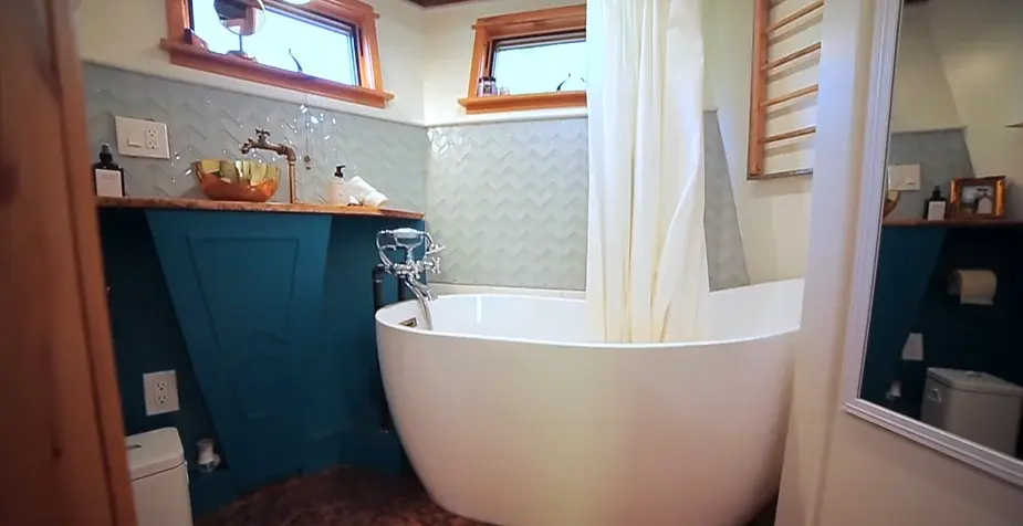 0253 Tiny house with reclaimed materials bathroom penny floor smallhometours.com 8