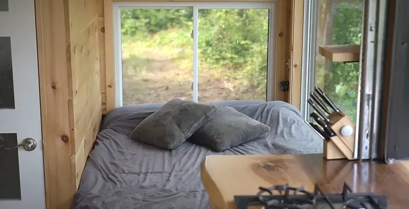 0380 Off grid tiny house with 4 solar panels dual bed design garage door window smallhometours.com 1