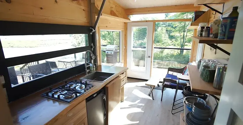 0380 Off grid tiny house with 4 solar panels dual bed design garage door window smallhometours.com 4
