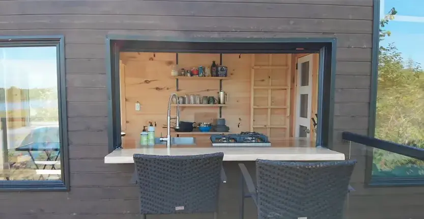 0380 Off grid tiny house with 4 solar panels dual bed design garage door window smallhometours.com 5