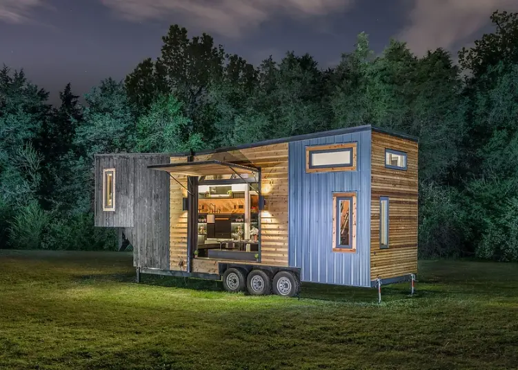 0486 Amazing tiny house with a table that pulls out from under the kitchen to accommodate up to 12 people smallhometours.com 2