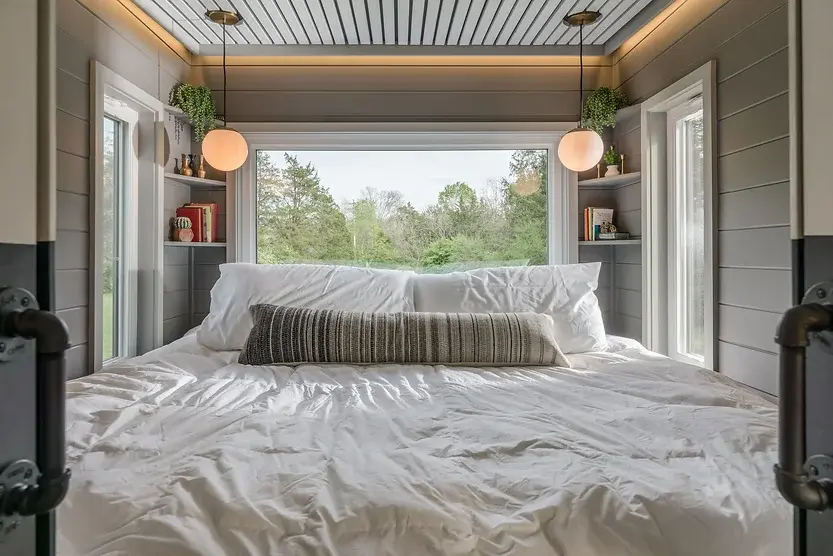 0486 Amazing tiny house with a table that pulls out from under the kitchen to accommodate up to 12 people smallhometours.com 3
