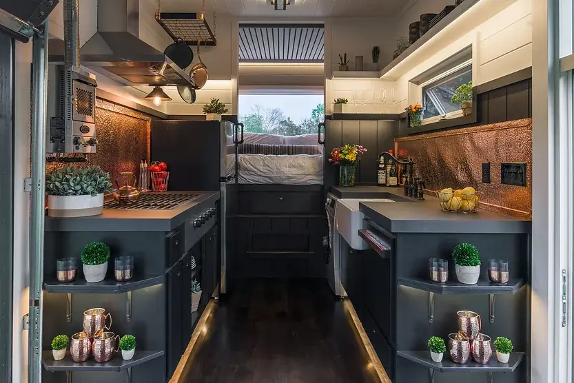 0486 Amazing tiny house with a table that pulls out from under the kitchen to accommodate up to 12 people smallhometours.com 6