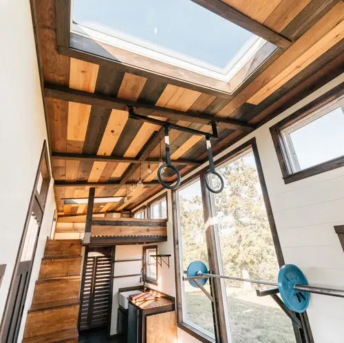 0533 Stunning 26 tiny house with crossfit workout gymnastics rings in living room smallhometours.com 11