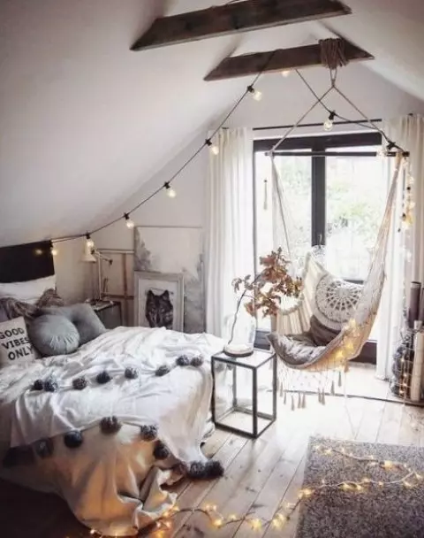 a boho attic teen room with a bed a suspended chair lights and lots of artworks is a lovely space to be