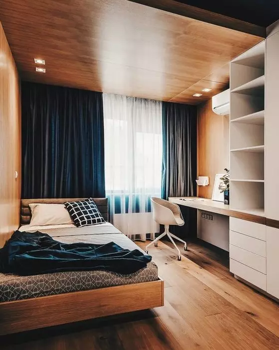 a bold minimalist teen room with a wooden ceiling with lights navy curtains a storage unit with a built in desk a comfy bed and blue bedding