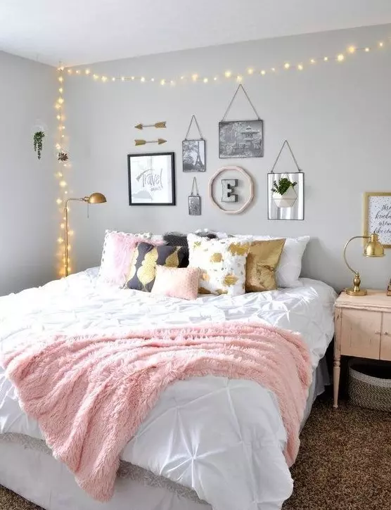 a chic teen girl bedroom with grey walls a large bed with printed pillows a lovely gallery wall and lights over the bed