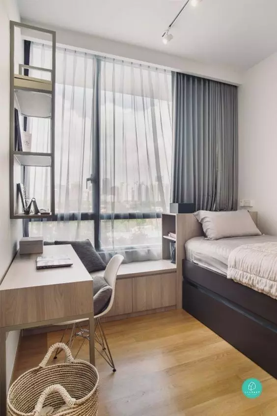 a neutral welcoming teen bedroom with a windowsill seat a desk and a chair a bed with storage drawers and a wall mounted shelf