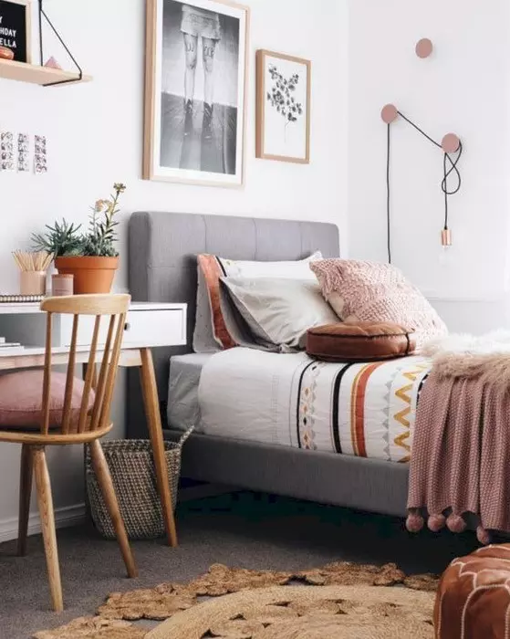 a stylish modern teen room with an upholstered bed a white desk a wooden chair a gallery wall and cool hooks