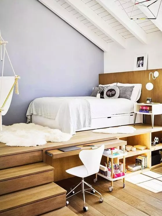 a teen room with a raised platform bed a built in desk and storage compartments a white chair and a suspended chair
