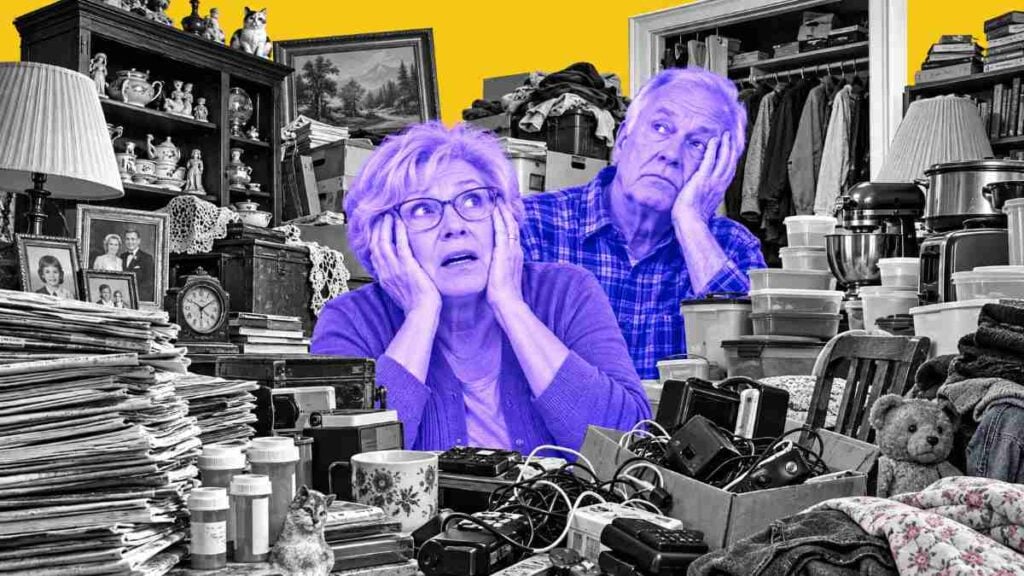 Editorial-style collage illustration of an overwhelmed older Caucasian couple surrounded by extreme household clutter. The woman in front holds her face in alarm while a man behind her rests his head in his hand, both tinted in bright purple-blue tones. Around them are towering piles of newspapers, pill bottles, tangled cords, old electronics, plastic containers, clothes, framed photos, kitchen appliances, and knickknacks, all set against a bold yellow background in a high-contrast black-and-white cutout style.