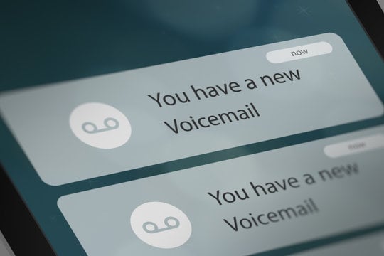 Close-up of a smartphone screen showing two notifications that read “You have a new Voicemail.”